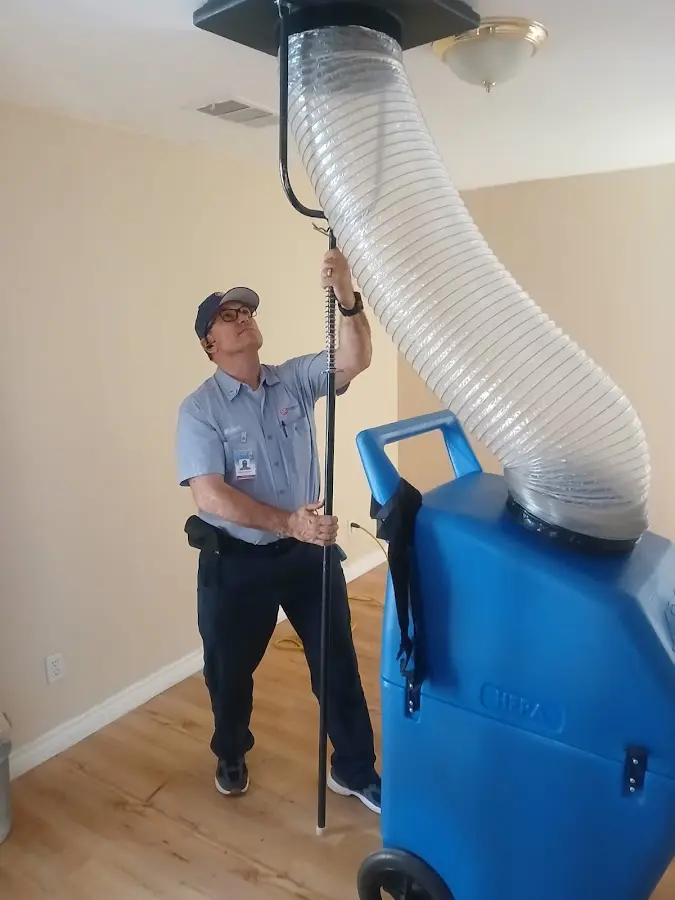 Furnace Tune-Up technician using HEPA equipment in Augusta